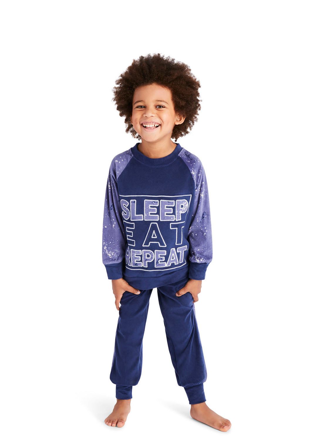 Little Boy wearing a Blue Splatter Pajama Set
